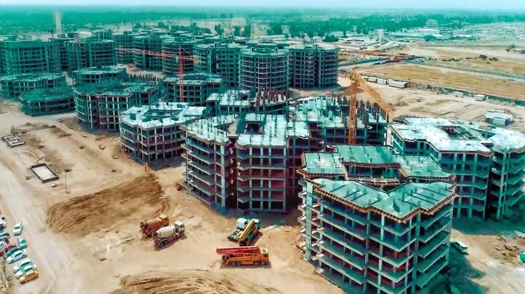 Aerial view of the Ben Farnas Complex under construction, with concrete frames and construction machinery on site