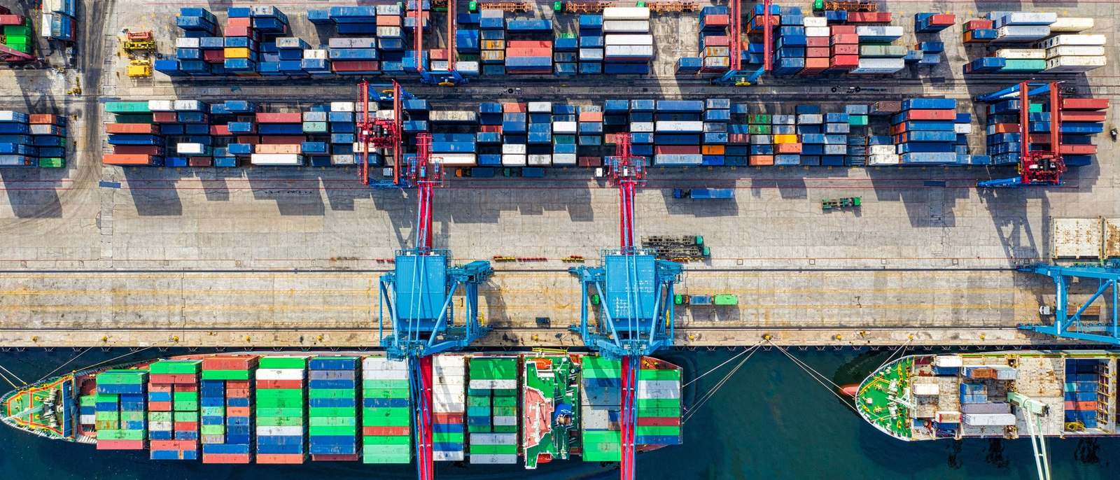 Rows of freight containers at a container terminal, seen from the air